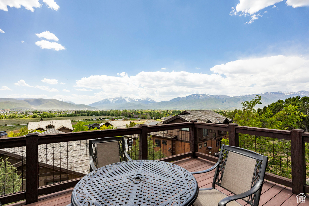 Deck featuring outdoor dining space and a mountain view