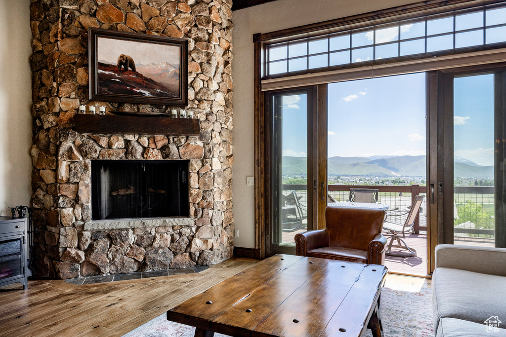 Living area with a mountain view, wood finished floors, and plenty of natural light