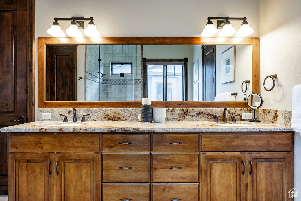 Bathroom with double vanity and a tile shower