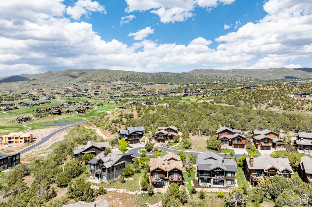 Aerial view of residential area with mountains and a local golf course