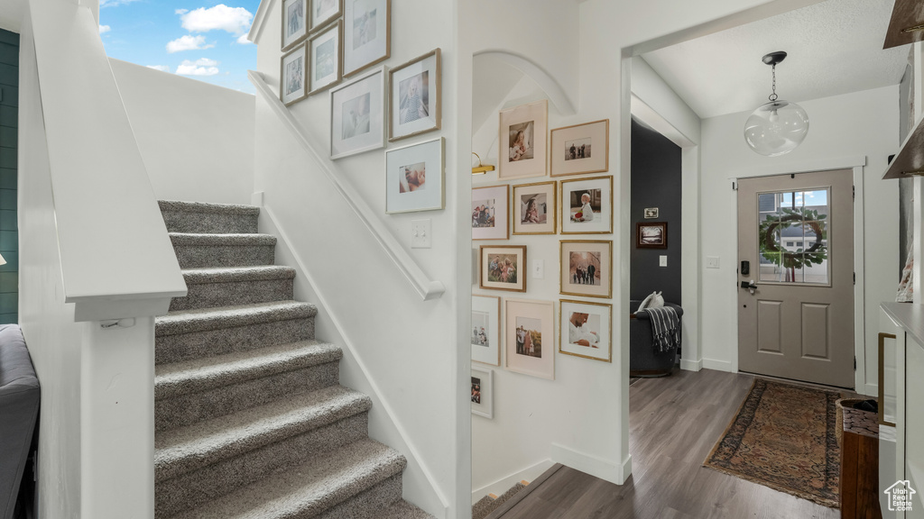 Entrance foyer featuring stairway and dark wood-style floors