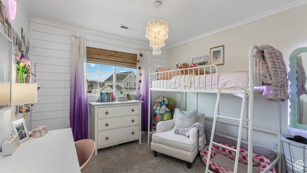 Bedroom featuring carpet flooring, crown molding, and a chandelier