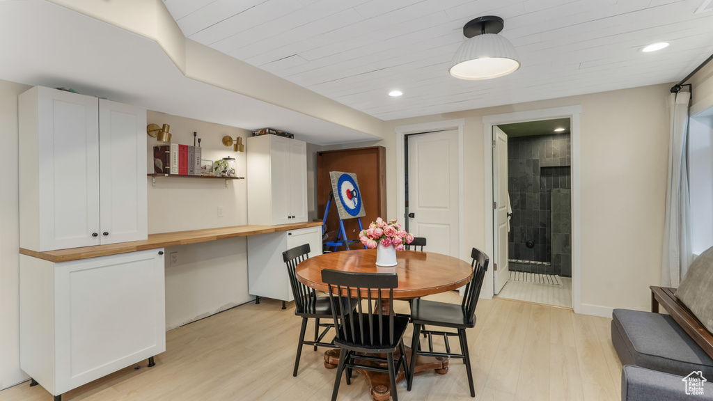 Dining room featuring light wood-style flooring, built in desk, recessed lighting, and wooden ceiling