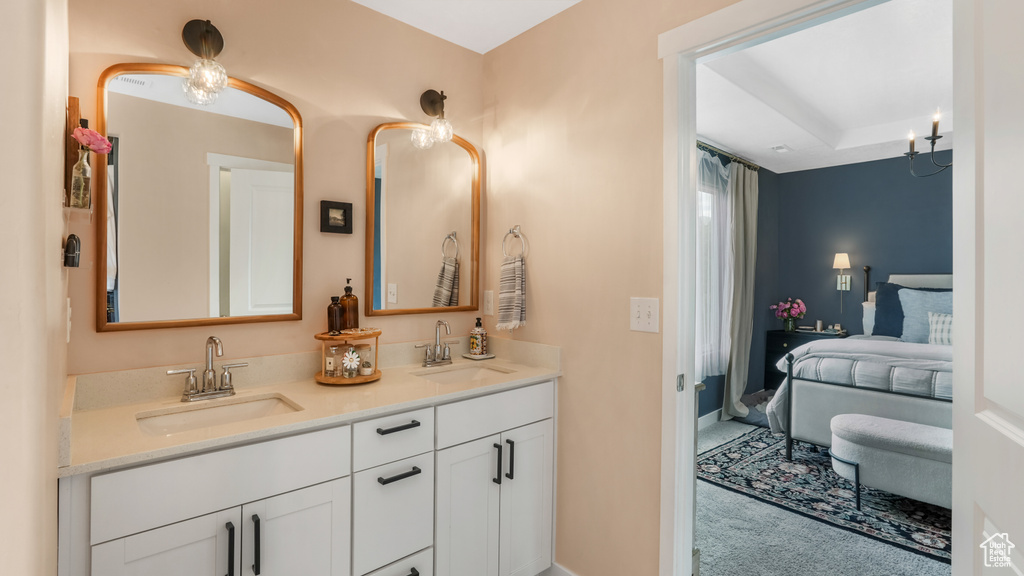 Full bath featuring double vanity and ensuite bathroom