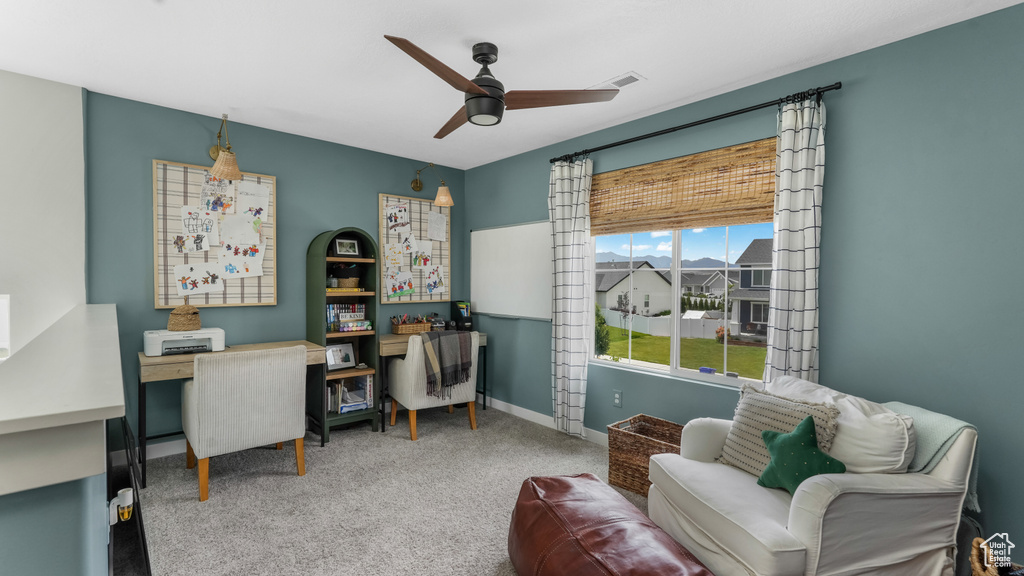 Office area featuring a ceiling fan and carpet floors