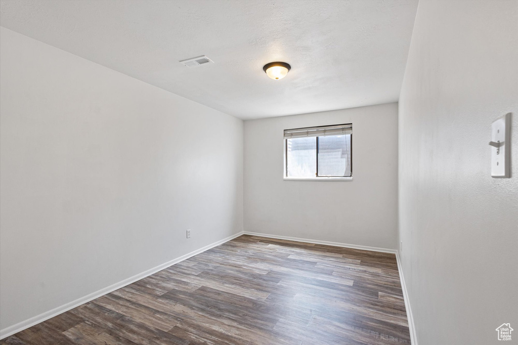Empty room with wood finished floors and baseboards