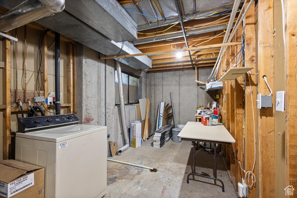 Unfinished basement featuring washer / dryer