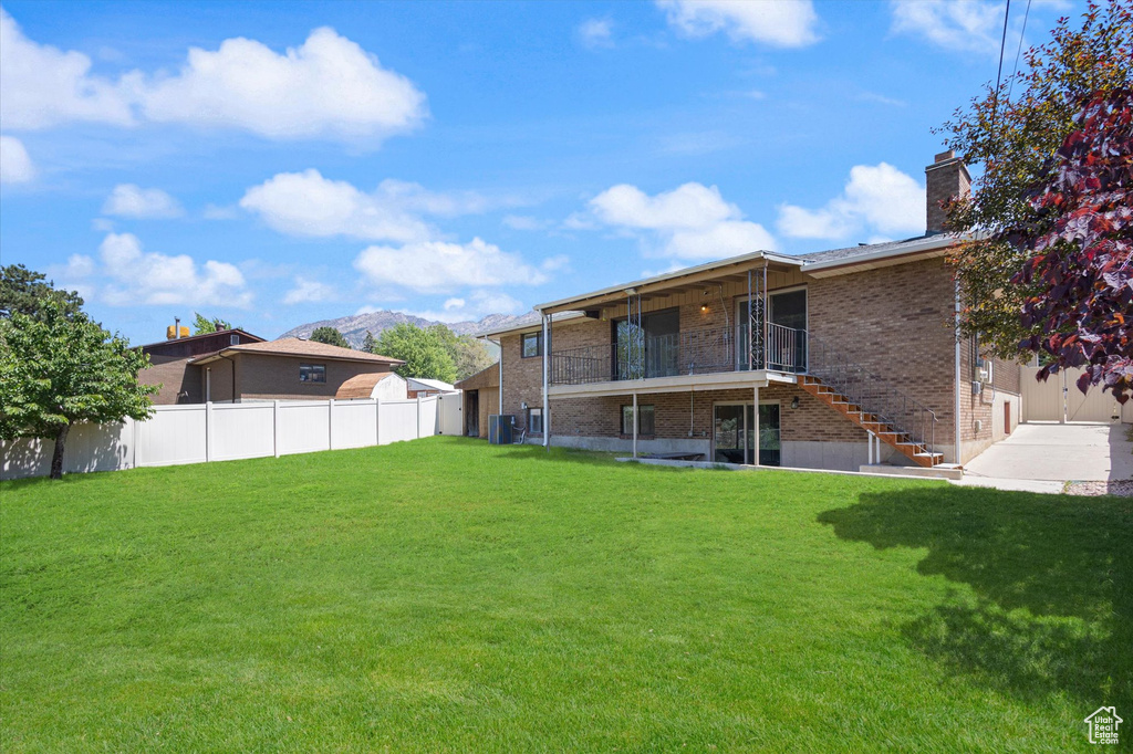 View of yard featuring stairway, central AC unit, and a mountain view