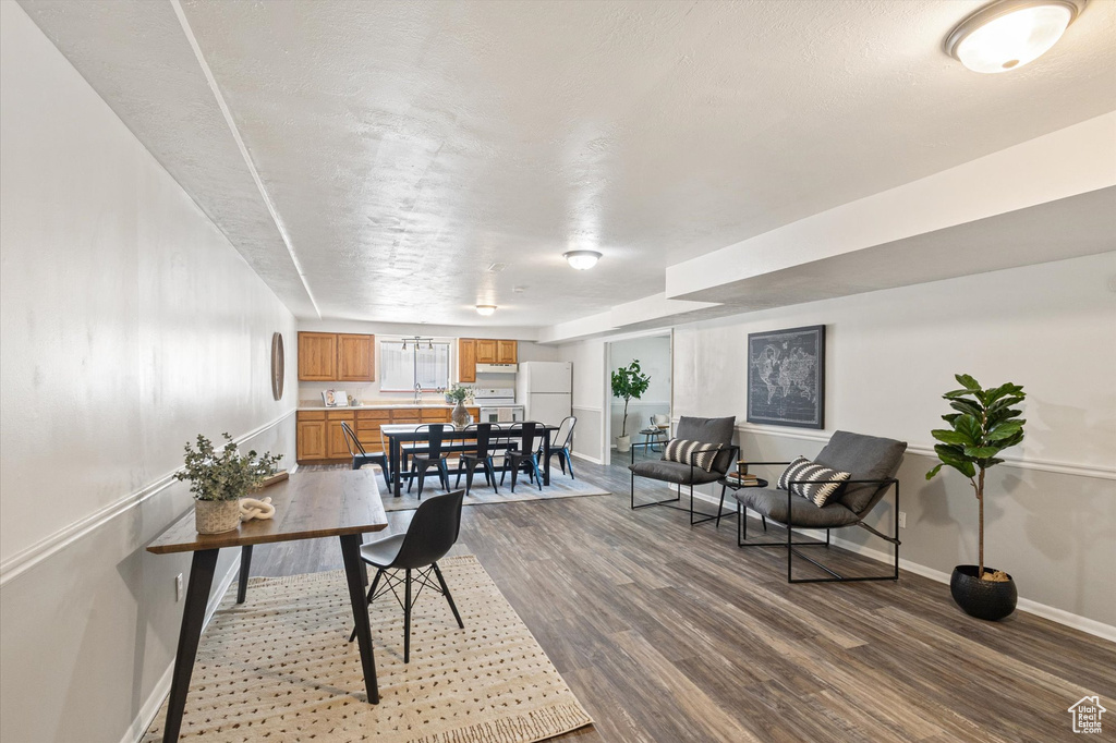 Home office featuring dark wood-style floors and baseboards