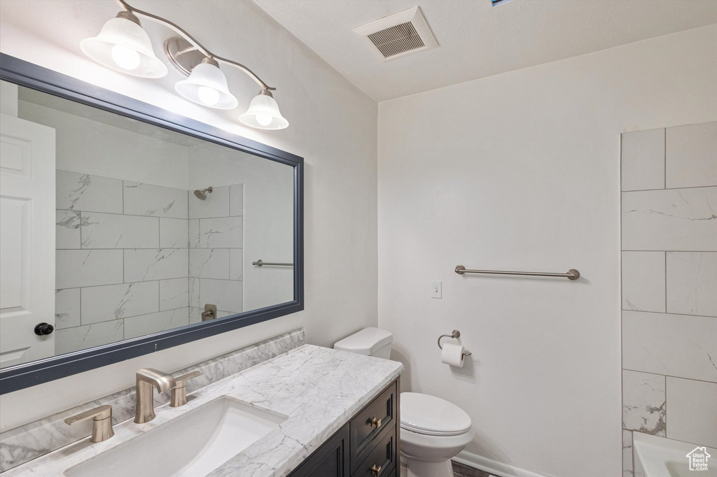 Full bath with vanity and toilet