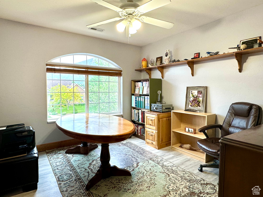 Office featuring light wood finished floors, ceiling fan, and baseboards