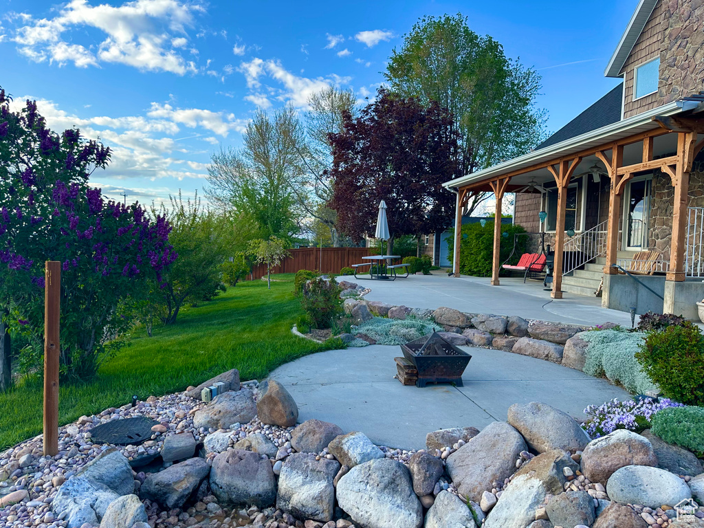View of yard featuring a patio and a fire pit