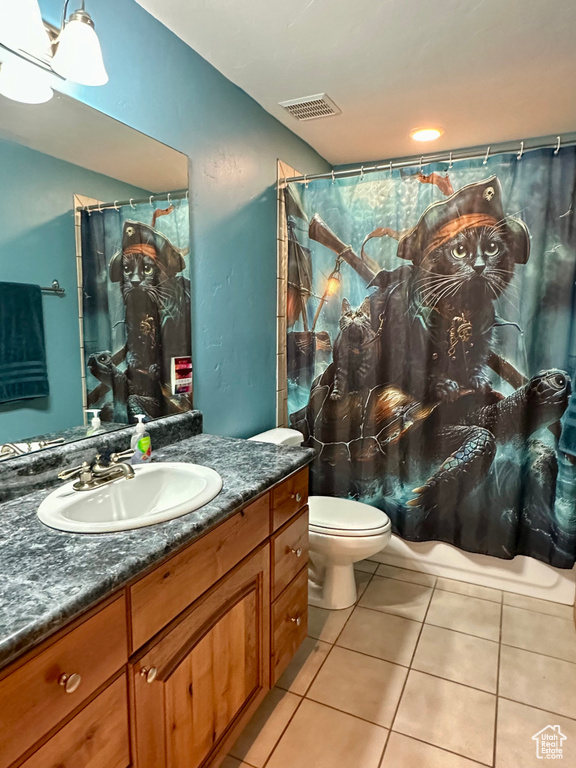 Full bathroom with vanity, toilet, tile patterned flooring, and a shower with shower curtain