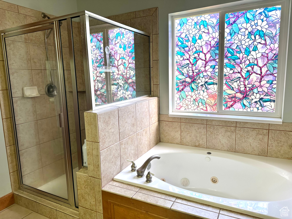 Bathroom featuring a shower stall and a whirlpool tub