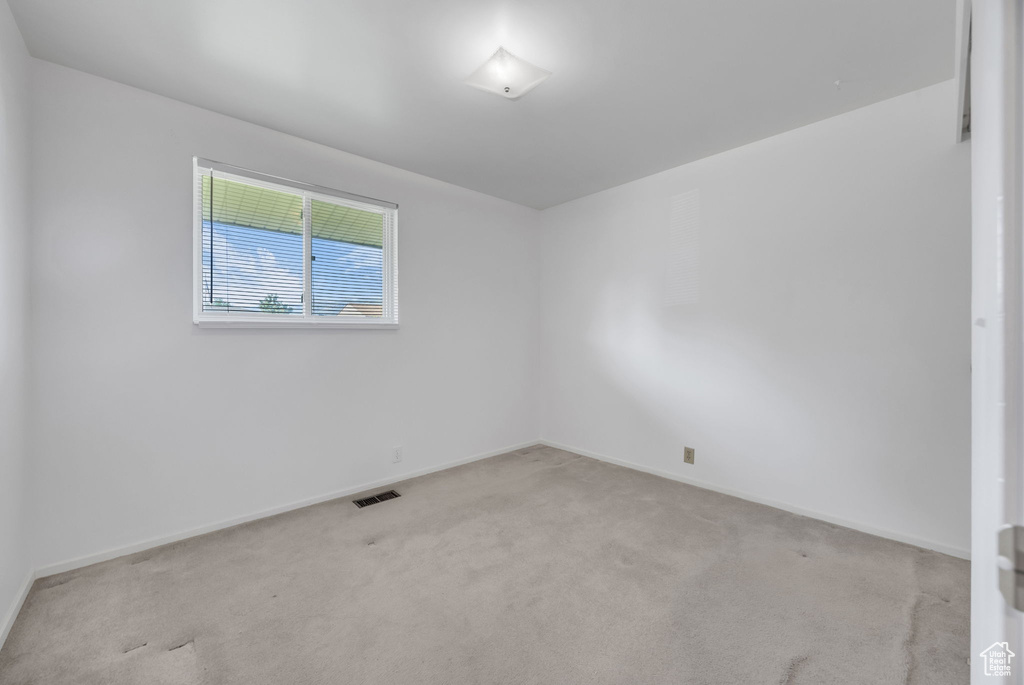 Carpeted empty room with baseboards