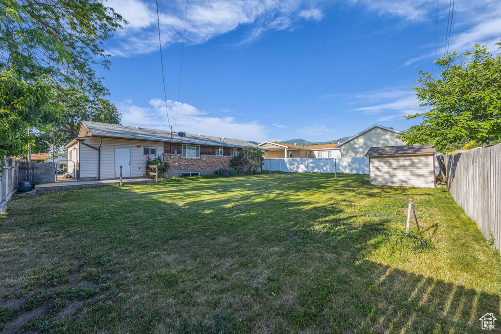 Fenced backyard with a storage unit