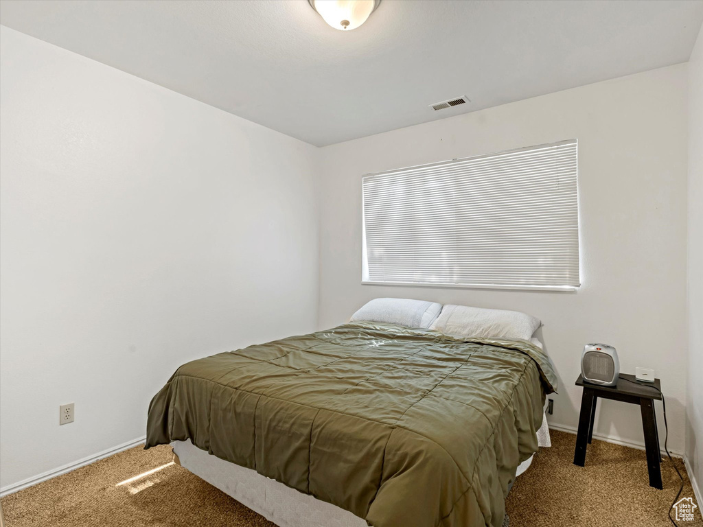 Carpeted bedroom featuring baseboards