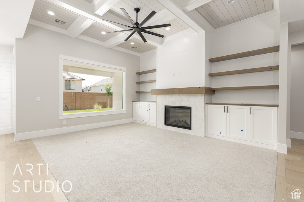 Unfurnished living room featuring beamed ceiling, recessed lighting, a fireplace, baseboards, and coffered ceiling