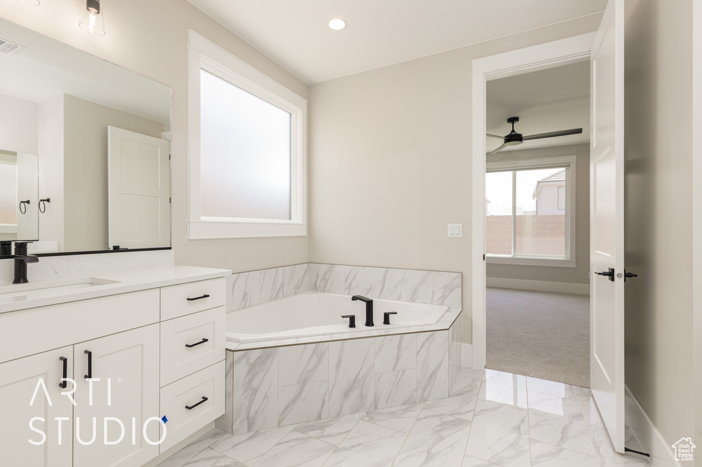 Full bath with vanity, marble finish flooring, a bath, ceiling fan, and recessed lighting
