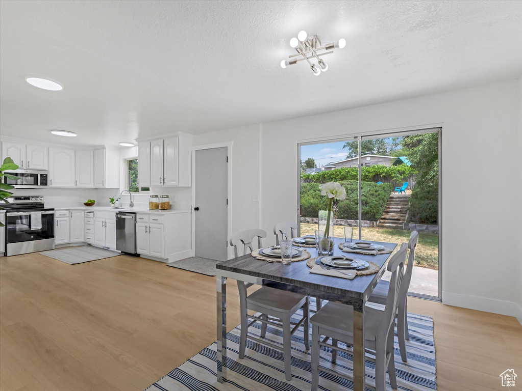Dining space with light wood-style floors and baseboards