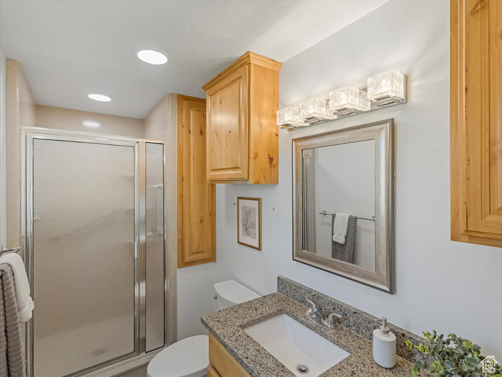 Bathroom featuring vanity and a stall shower
