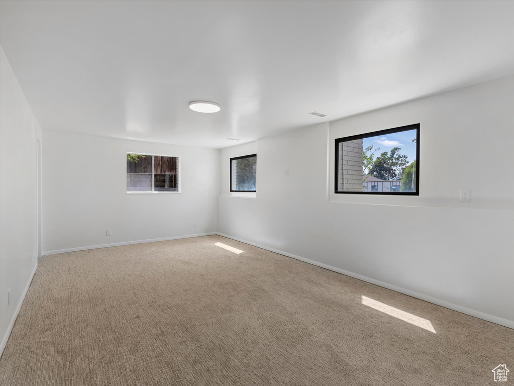Carpeted empty room featuring baseboards
