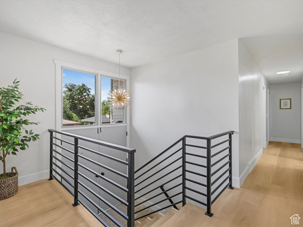 Staircase featuring wood finished floors and baseboards