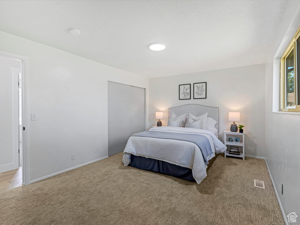 Carpeted bedroom featuring baseboards