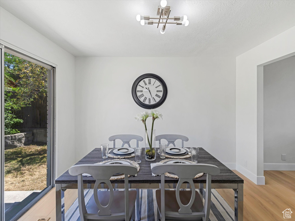 Dining area featuring a chandelier and light wood-style flooring