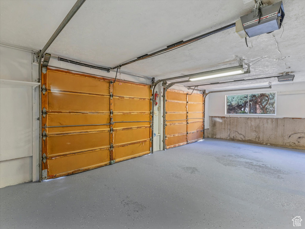 Garage featuring a garage door opener