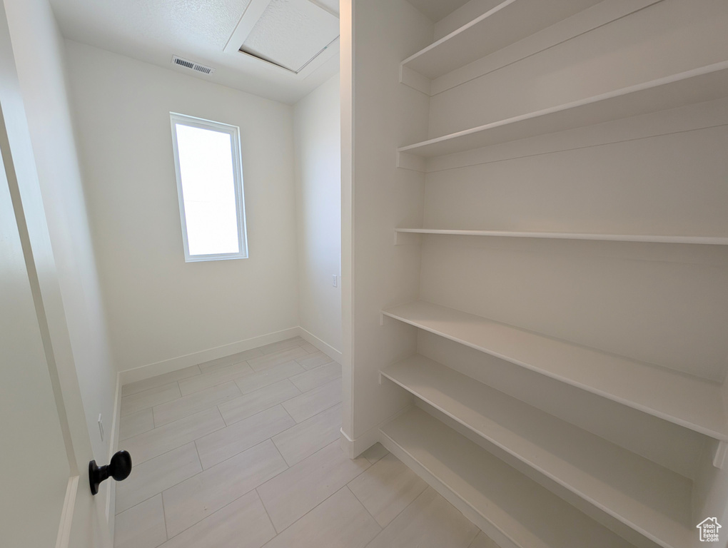 Walk in closet featuring light tile patterned floors