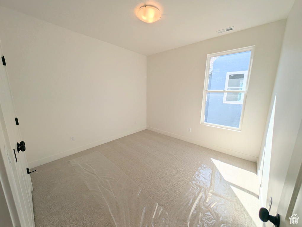 Unfurnished room with carpet
