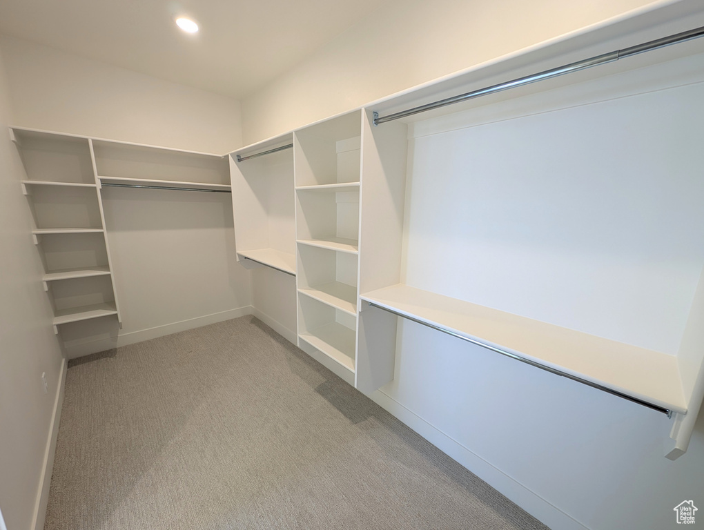 Walk in closet with light carpet