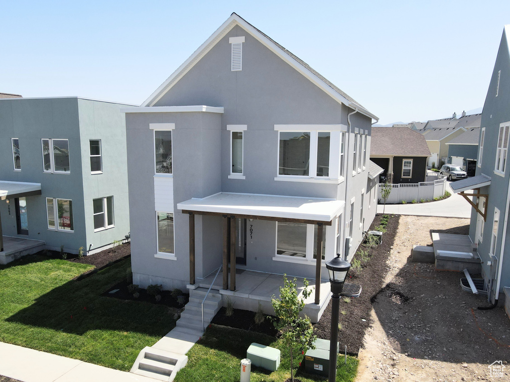 View of front of house with stucco siding and a porch