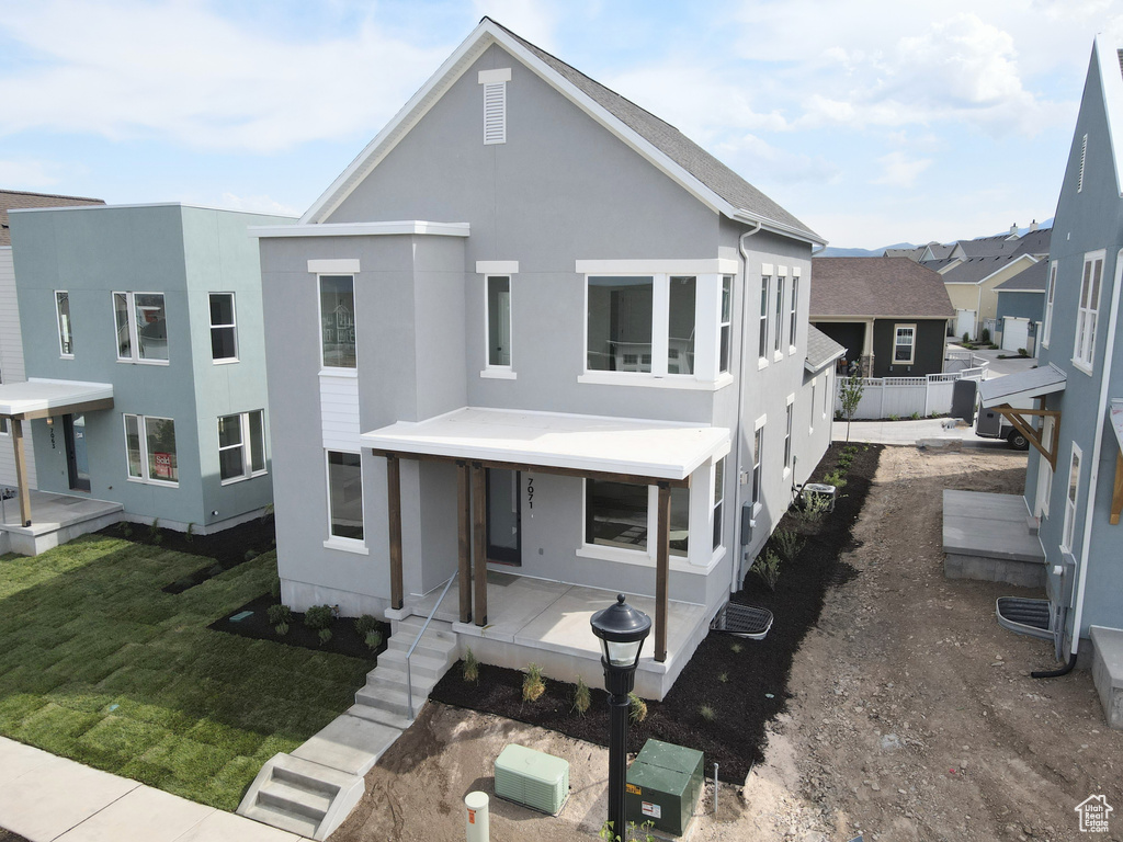 View of front facade featuring stucco siding