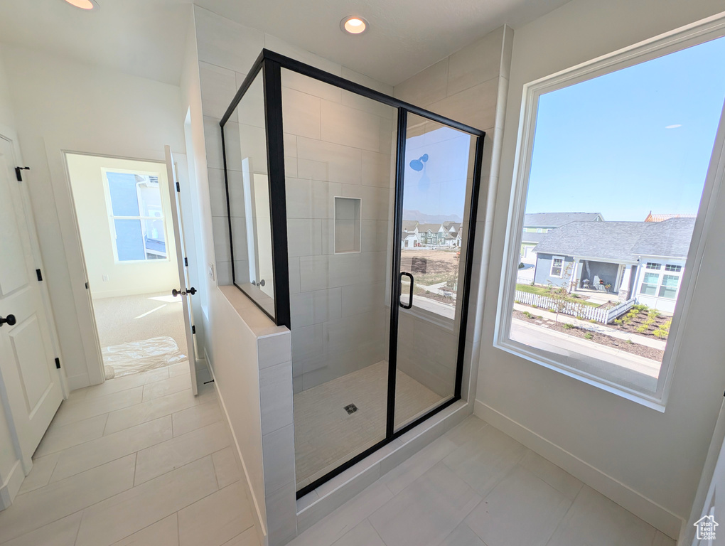 Bathroom featuring a shower stall, recessed lighting, and tile patterned flooring