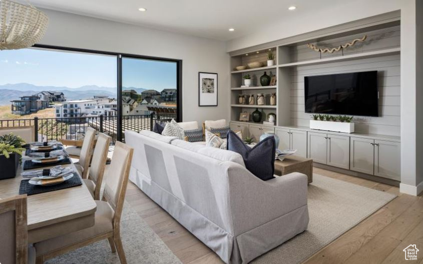Living room featuring a mountain view, light wood-style floors, and recessed lighting