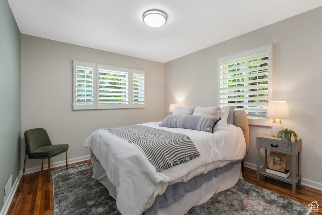 Bedroom featuring multiple windows and wood finished floors