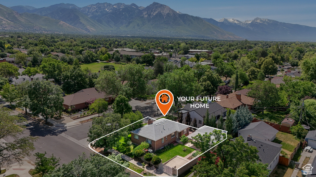 Aerial perspective of suburban area with property boundaries highlighted and a mountainous background