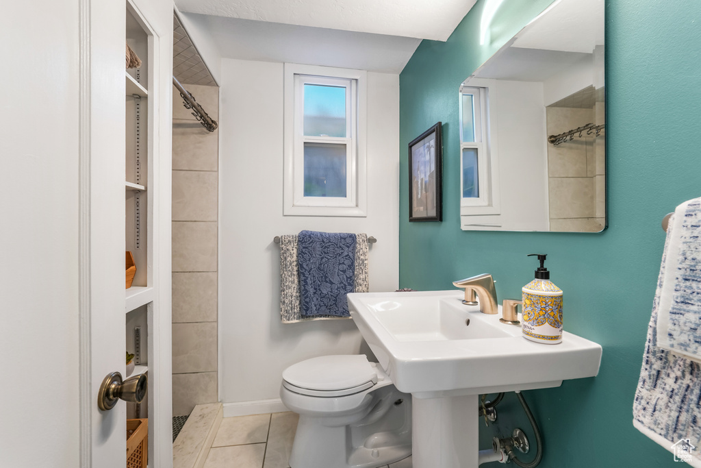Bathroom featuring toilet and tile patterned flooring