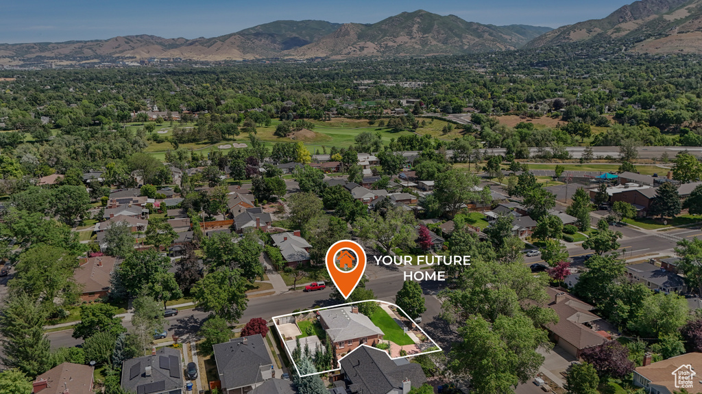 Aerial overview of property\'s location with property parcel outlined, mountains, and nearby suburban area