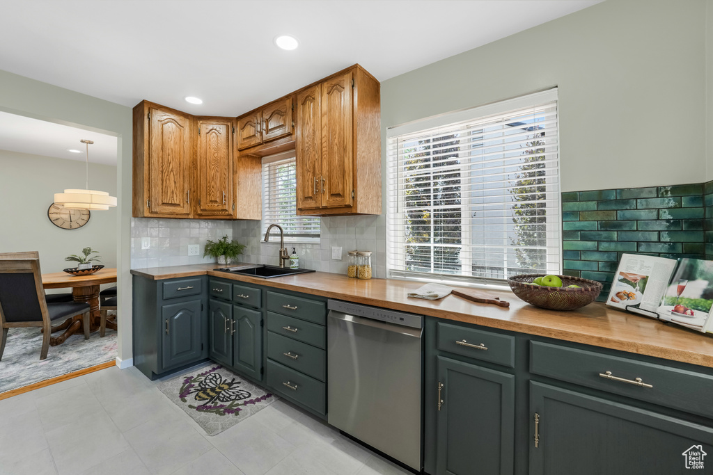 Kitchen featuring dishwasher, backsplash, recessed lighting, and wood counters