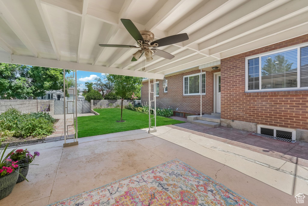 View of patio / terrace with ceiling fan and a gate