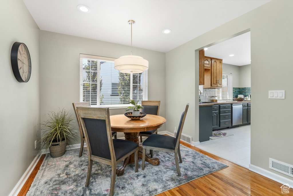 Dining area featuring light wood-type flooring and recessed lighting