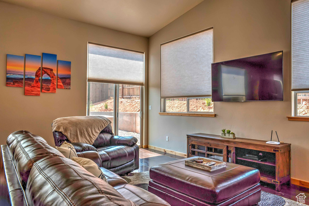 Living room with baseboards and lofted ceiling