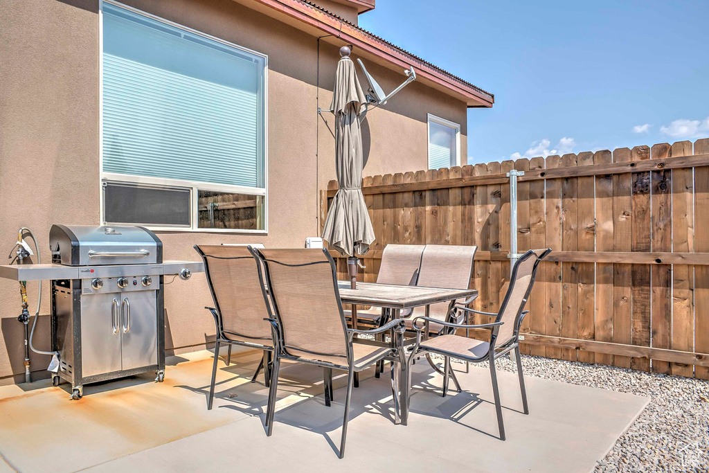 View of patio with area for grilling and outdoor dining space