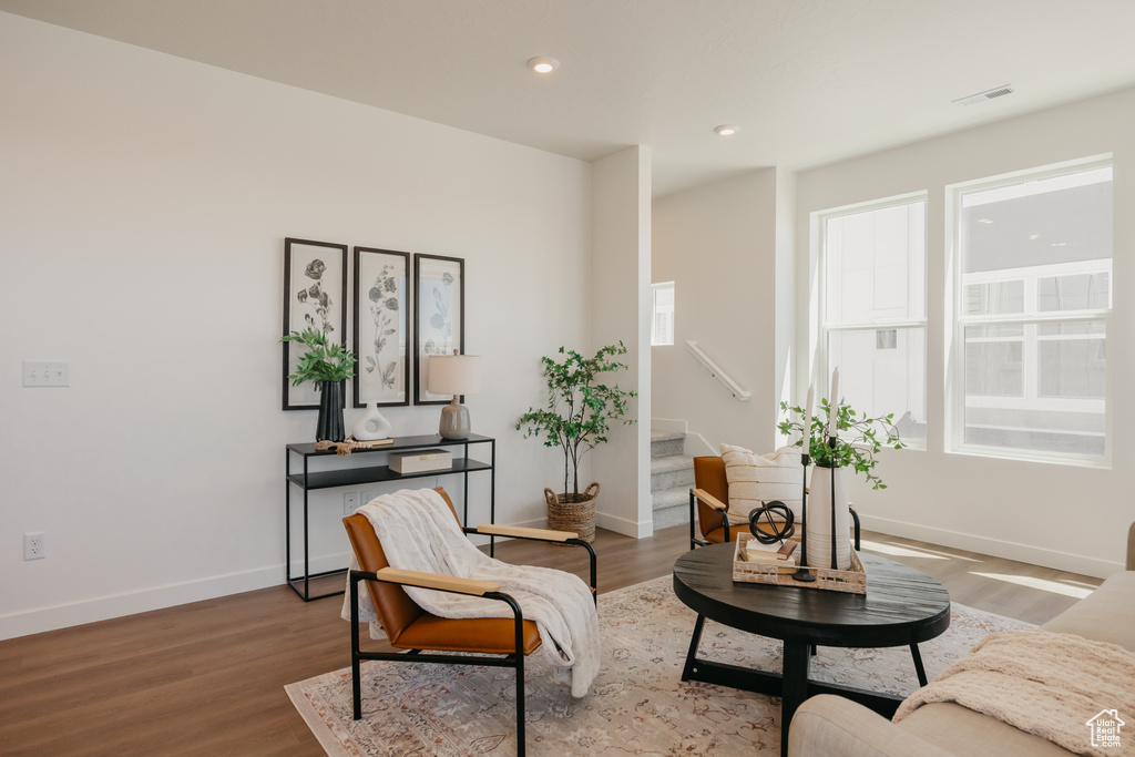 Living area featuring stairway, wood finished floors, and recessed lighting