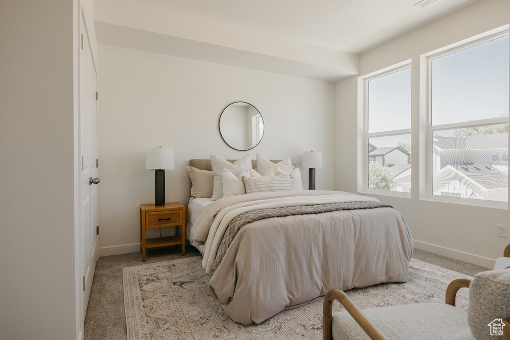 Bedroom featuring light carpet