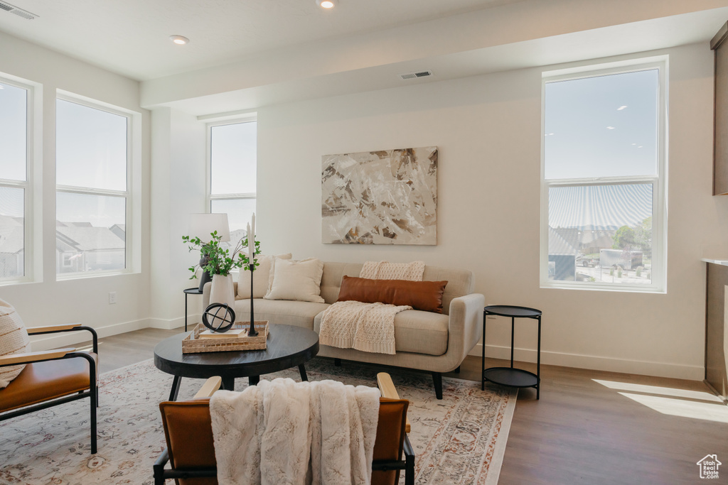 Living area with wood finished floors and recessed lighting