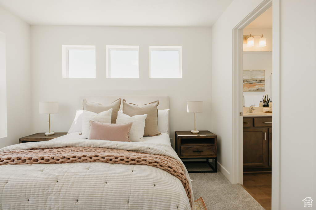 Bedroom featuring multiple windows and ensuite bath
